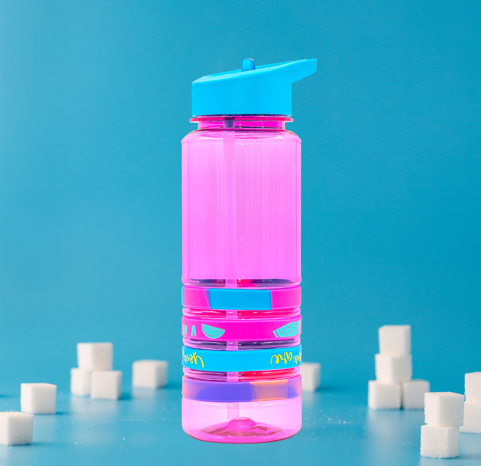 The before image of a pink and blue water bottle surrounded by sugar cubes.