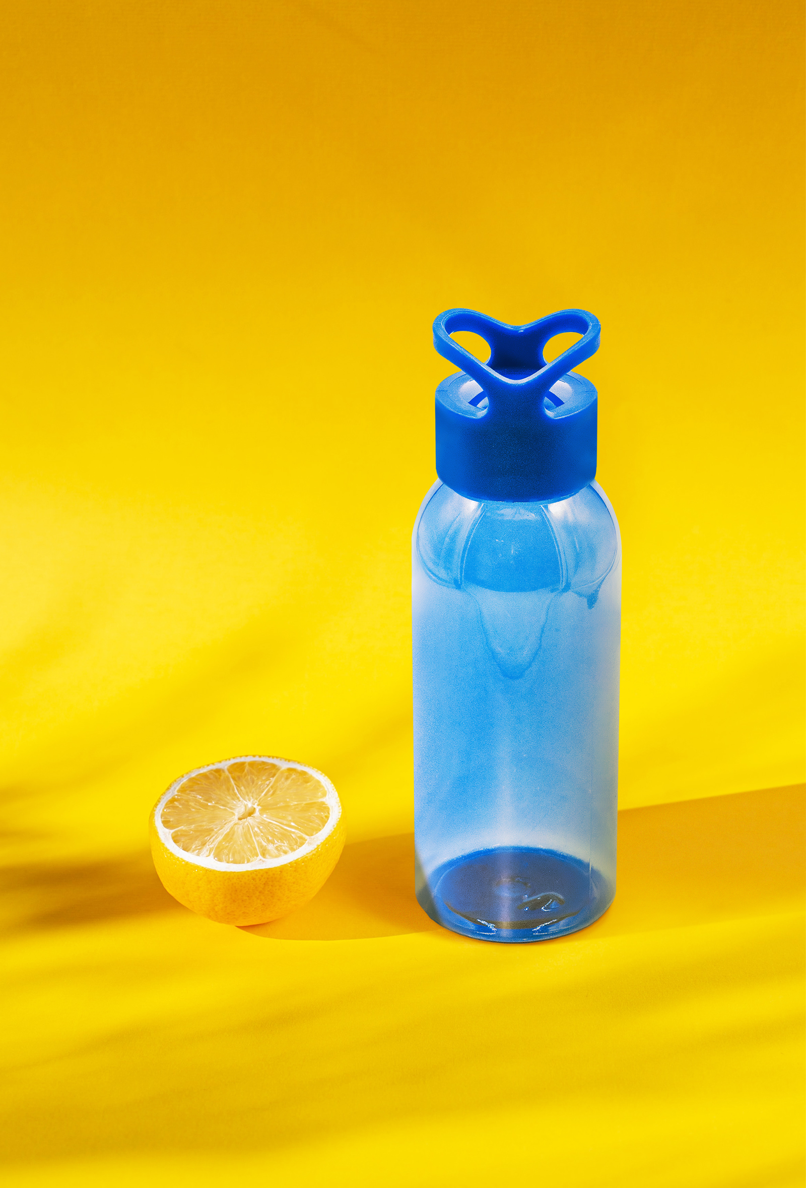 The after image of blue water bottle on a yellow background.